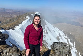 A picture of Mhari standing at the top of a mountain in Scotland