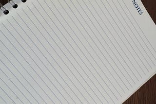 Spiral-bound lined notebook symbolizing preparation and organization in academic presentation coaching for researchers.