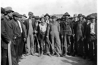 black and white picture of people on strike. Or maybe it’s a picture of something else. I don’t really know. I just took the picture from one of Philip’s story, which you should NOT read