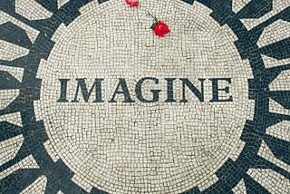 An iconic picture of New York City’s Central Park’s tribute to John Lennon: the “Imagine” mosaic seen from above with two roses lying on the tiles.