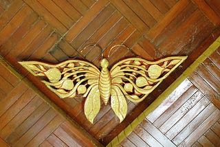 A golden bee in the rooftop corner of a house in Myanmar