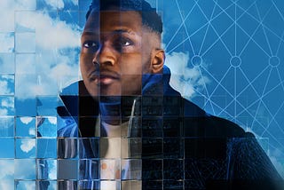 This image shows a young black man wearing a black coat staring past the camera in front of a blue cloudy sky. The scene is refracted in different ways by a fragmented glass grid. This grid is a visual metaphor for the way that new artificial intelligence (AI) and machine learning technologies can be used to extract and analyse behavioural and demographic data in innovative ways.