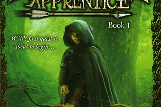 Clad in a dark green hooded cloak, a teenage boy faces the viewer as he holds ready a notched arrow in his bow. Behind him can be seen stout trees, a light green fog pervading the forest in which they stand. ‘Ranger’s Apprentice' appears at the top in large gold text and is underlined by an arrow, followed by ‘Book 1’.