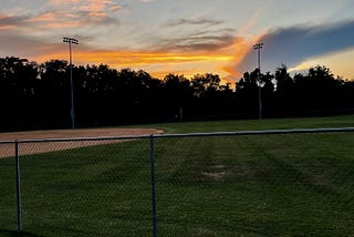 a baseball diamond at sunset