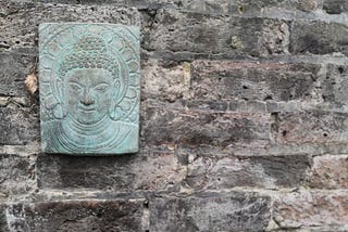 Buddha plaque on stone wall