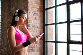 Girl in sports bra with headphones on