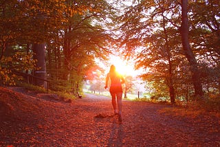 A woman runs in the woods training for a marathon