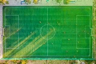 Overhead view of a soccer field with players.