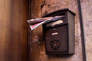 Mailbox with junk mail falling out of it