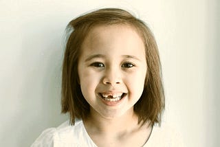 A child with a front tooth missing