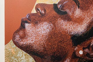 A close-up of a mixed media portrait of a young Black woman in profile, head tilted upward to the left, her countenance regal and serene. The woman’s cheekbones and contoured cheeks are illuminated in white oil pastel, small circles creating the illusion of contour. Her skin is painted a rich terra cotta, contrasted against her striking black hair and thick lashes. The woman’s profile sits on a flat backdrop of warm earth tones and embossed floral paper.