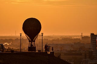 Sunset in a city east of Moscow with observation balloon.