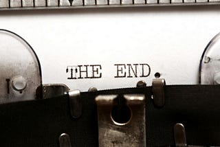 Photo of typewriter with the end — text on page