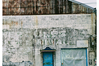 Patina warehouse building Bywater New Orleans Must I Evolve? by Andrew H. Housley