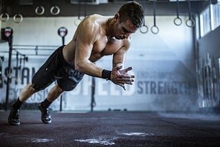 A man practicing push-ups for body strength training.