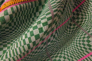 green and white binakul patterned inabel cloth with pink and orange details