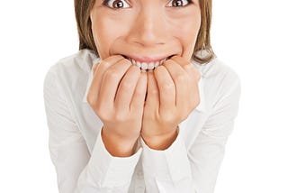 Nervous businesswoman bites her nails nervous about giving a speech