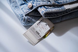 Price tag attached to a pair of blue jeans.