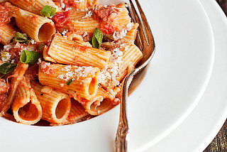 Rigatoni with pancetta and green onions in vodka sauce