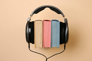 A horizontal pile of books wearing headphones
