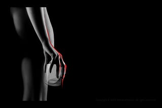 Naked woman from the back holding an empty glass with blood dripping off her fingers