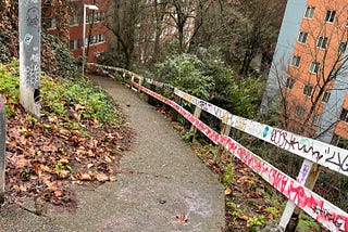 Steep trail descends through tall apartment buildings