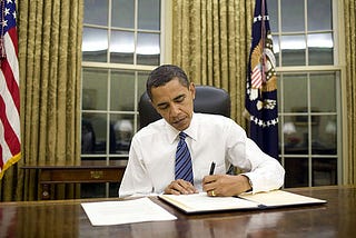 President Obama signing a bill into law.