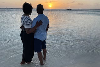 Black married couple on a beach in Aruba. K. Joseph and hubby. Image © K. Joseph.