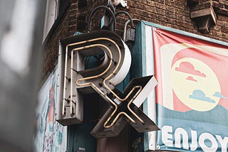 Closeup of Rx sign on corner of brick building