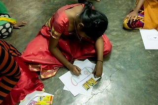 A child drawing her ‘superhero mask’