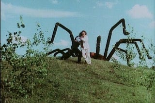 Someone runs away from the Giant Spider, which is just a car with nylon legs on it.