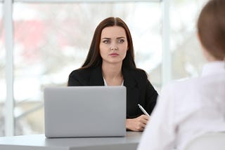 Image of a Senior Women Executive giving feedback to a Team Member