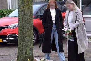 People lay flowers near house in Winsum where Zbigniew Symonowicz lived