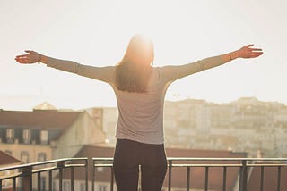 Person holding arms up to sun