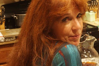 Author’s online profile picture — redhead, looking over shoulder with slight grin on face