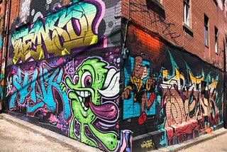 Montreal. Cartoonesque mural wrapping around a corner of a brick building.