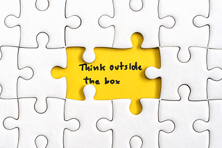 A white puzzle shows a sentence: “Think outside the box”