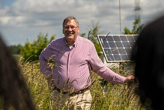 Steve standing in a field at the University of Leeds Research Farm, smiling at the camera