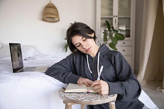 woman writing on notebook