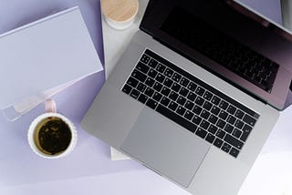 A laptop and a coffee mug on adesk