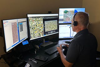 An officer and certified drone operator at Campbell Police Department in northern California flies a drone remotely from the department’s flight room, where they can view live footage captured by the drone and rooftop-mounted cameras. (Photo courtesy of Campbell PD)