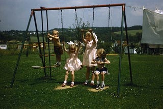 Children playing on a swing set