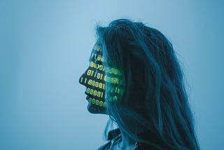 Woman with computer code reflected on her face