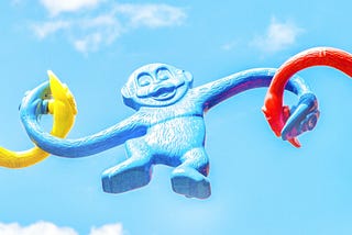 Colorful plastic monkeys from the monkey barrel children’s game are connected together to form a long strand