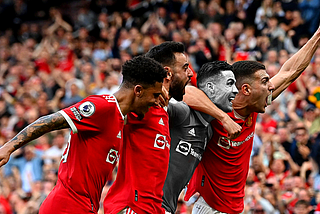 Cristiano Ronaldo celebrating a goal with his teammates at Old trafford