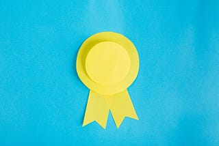 A yellow rosette set against a blue background