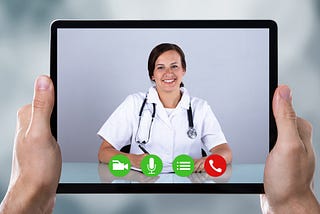 Doctor appears on tablet being held by a patient utilizing telehealth services