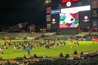 baseball field with big screen showing looney tunes cartoon