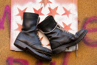 A pair of black boots with white laces