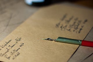 a fountain pen on a brown envelope.